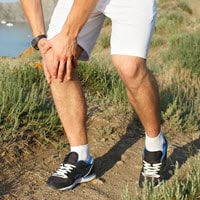 man suffering from arthritis on an outdoor walk
