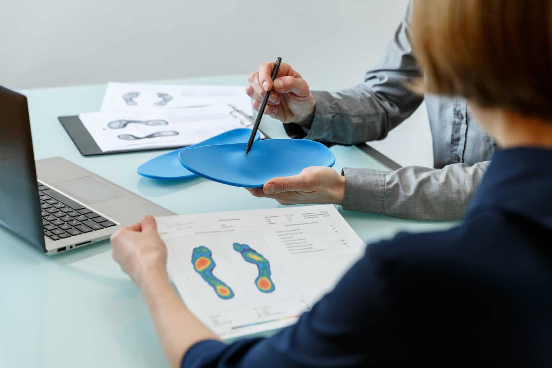 Podiatrist explaining Orthotic Therapy to a patient